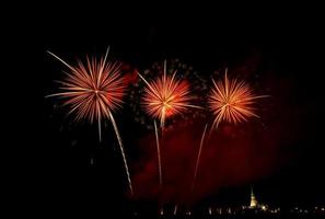 Huge, colorful fireworks over the rice fields at dusk. photo