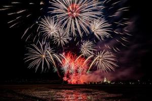 Huge, colorful fireworks over the rice fields at dusk. photo