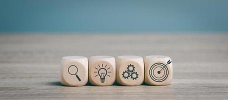 Wooden blocks lined up on a desk, goal setting idea. and business strategy through planning and teamwork To analyze and develop the company's performance from growth to future data. photo