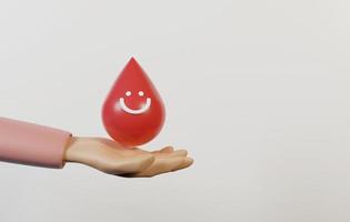 mano que sostiene el icono de gota de sangre con cara sonriente entregado sobre fondo blanco. foto