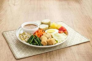 Gado Gado, Indonesian traditional vegetable salad with peanut sauce, rice cake, tofu and egg photo