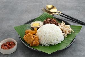 Gudeg, a typical food from Yogyakarta, Indonesia, made from young jackfruit cooked with coconut milk. Served with spicy stew of cattle skin crackers, brown eggs, shredded chicken and sambal. photo