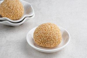 Onde-Onde is traditional food from Indonesia made from glutinous rice flour with beans pasta, wrapped in sesame seeds. Popular Indonesian snack with Chinese influence. photo