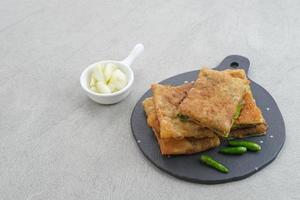 Martabak, Martabak Telor or Martabak Telur. Savory pan-fried pastry stuffed with egg, meat and spices. Martabak Telur is one of Indonesia street food.