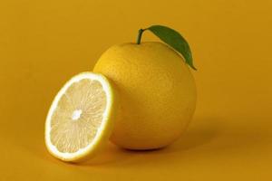 A lemon fruit with Lemon slice and leaf isolated on white background. A concept of healthy fruit design photo