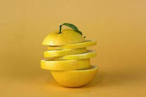 Lemon fruit slice in layers isolated on yellow background photo