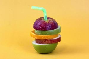 Sliced apple with piece of lemonand green apples isolated on yellow background. New isolate style for Fruit concept photo