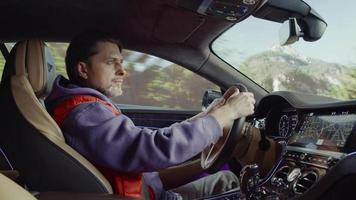 Bentleydriver adjusts rearview mirror,a track in the mountains video