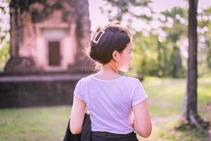 Slim teenage girl looking amazing scenery Explore ancient sites. photo