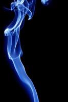 Blue smoke on black background photo