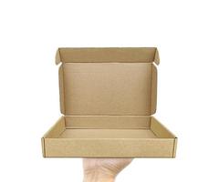 Empty cardboard box with copy space in the male hands on the white background photo