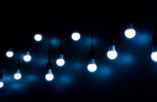 Open Light bulb on black background.add blue color photo