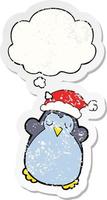 cute christmas penguin and thought bubble as a distressed worn sticker vector