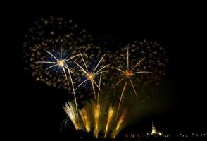 Huge, colorful fireworks over the rice fields at dusk. photo