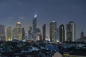 High-rise building in the capital city of Thailand Bangkok office area Night light from the building photo
