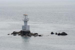 Seaside lighthouse And seems to be in the sea when the water rises photo