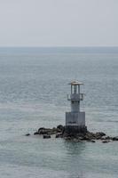 Seaside lighthouse And seems to be in the sea when the water rises photo
