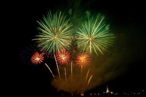 Huge, colorful fireworks over the rice fields at dusk. photo