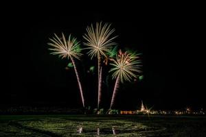 Huge, colorful fireworks over the rice fields at dusk. photo