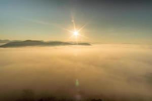 Morning fog covers Lamphun, Thailand, view from the viewpoint of Wat Phra That Pha Temple photo
