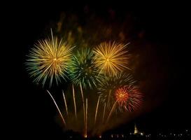 Huge, colorful fireworks over the rice fields at dusk. photo