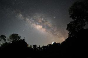 The Milky Way above the tree shadow on the top of the mountain photo