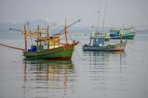 A small fishing boat is anchored. Stop back from Fishing near the coast photo