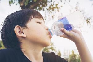 Boy drinking water photo