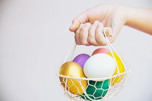 Child showing colorful Easter eggs happily - Easter holiday celebration concept photo