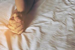 Man holding woman hand on white bed, couple sexual concept photo