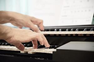 Man hand play electone keyboard - people with music concept photo