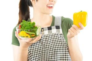 Happy lady holding kichen stuff over copy space background - people home made food preparation concept photo