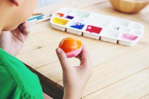 People painting colourful Easter eggs - people celebration national holiday concept photo