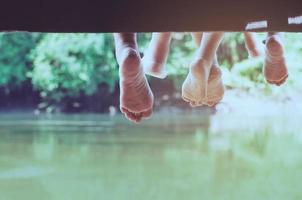 People sitting relax on pier over river background show freedom lifestyle - slow life relax in green nature concept photo