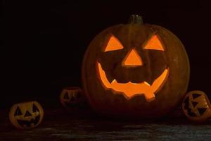 Halloween pumpkin head jack lantern on wooden background photo