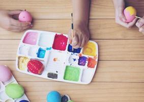 People painting colourful Easter eggs - people celebration national holiday concept photo