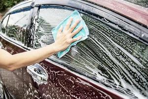 Man wash car using shampoo - every day life car care concept photo