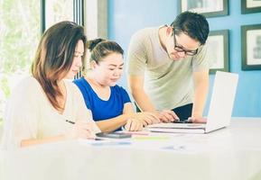 Vintage style photo of two women and one man are working in modern office