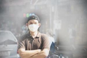 Man wearing mask protect fine dust in air pollution environment - people with protection equipment for air pollution concept photo