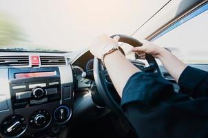 Close up of a man driving car using two hands photo