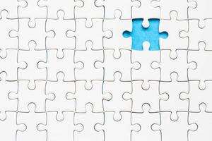 White part of jigsaw puzzle pieces on blue background. concepts of problem solving, business success, teamwork, Team playing jigsaw game incomplete, Texture photo with copy space for text