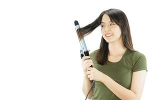 Beauty woman take care her hair using hair stretcher isolated over white background - people with hair care concept photo