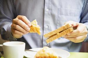 Business man eat the American breakfast set in a hotel - people take a breakfast in hotel concept photo