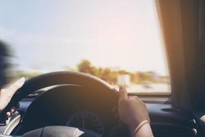 Woman driving car using two hand photo