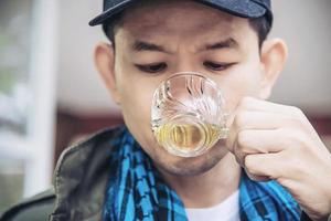 Happy man drink hot tea cup - asian people with hot tea drink relax concept photo