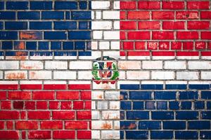 National  flag of the Dominicana  on a grunge brick background. photo