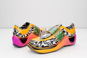 Bright sneakers with animal print on the sole. The concept of bright fashionable sneakers, 3D rendering. photo