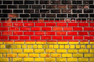 National  flag of the Germany on a grunge brick background. photo