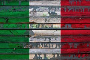 The national flag of Italy is painted on uneven boards. Country symbol. photo