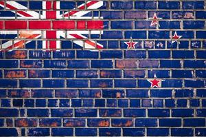 National  flag of the New Zealand on a grunge brick background. photo